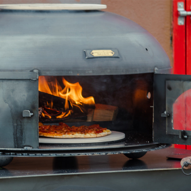 Firepits UK Dome Oven close up with door open with pizza