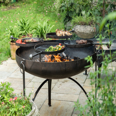 Firepits UK Plain Jane 120 Fire Pit with Four Swing Arm BBQ Racks front view cooking