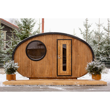 front view of hobbit sauna in snowy garden