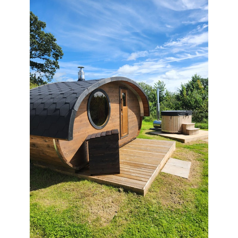 hobbit sauna cabin outside next to hot tub